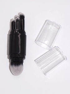 Detail of multi-functional black makeup brush with detachable heads and transparent cap