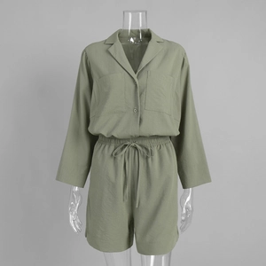 Detail of sage green shirt and drawstring shorts set with woven linen texture fabric