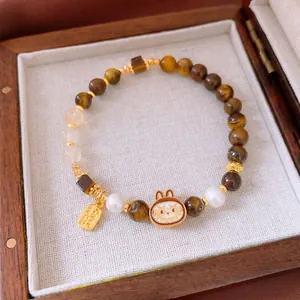 Bracciale di perle occhio di tigre con ciondolo a coniglio dorato e targa fortuna