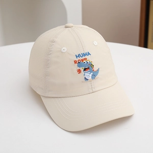 Detail of embroidered dinosaur on a beige kids' baseball cap with breathable eyelets