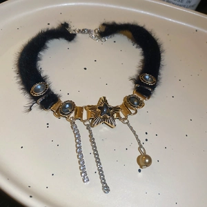Detail of plush choker featuring a gold star pendant with rhinestone and pearl tassels