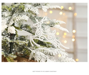 White reindeer Christmas ornament with glitter finish hanging on a snowy branch