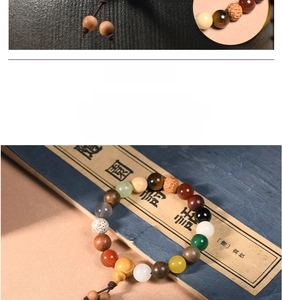 Detail of multi-material Buddhist prayer beads with a wooden gourd on classical book background