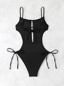 Detail of black cutout swimsuit showing adjustable straps and front lace-up design