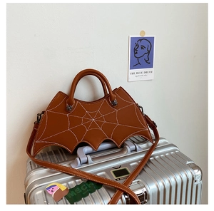 Close-up of brown PU leather bag featuring bat wing design and white cobweb stitching