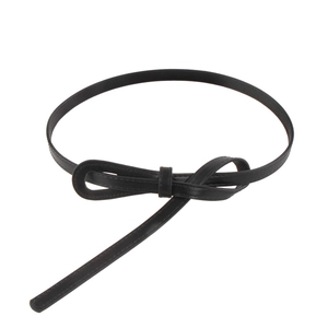 Minimalist black slim waist belt for women with elegant knot design on white background