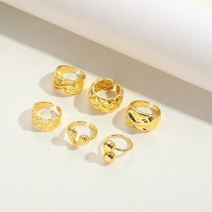 Detailed macro view of 6-piece golden adjustable ring set with diverse hammered textures