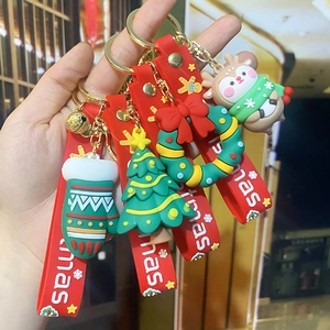 Cartoon Christmas keychain collection featuring Santa, deer and tree styles with red strap