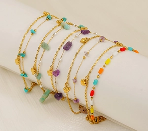 Detailed view of layered titanium steel heart bracelets with colorful natural stones