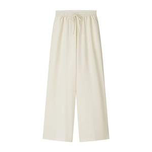 Close-up of cream wide-leg trousers featuring elastic waistband and vertical texture