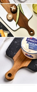 Detail of acacia wood and marble cutting board with handle and hanging hole for kitchen