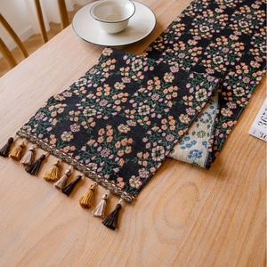 Minimalist Christmas table runner with colorful floral jacquard and elegant tassels