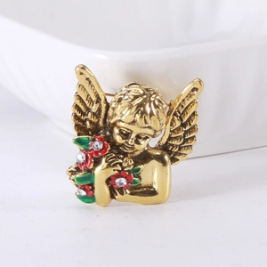 Macro shot of a vintage golden angel brooch with colorful enamel flowers and rhinestones