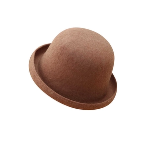 Detail view of the smooth wool felt texture and rolled brim on this brown bowler hat