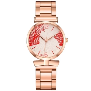 Detail shot of the rose gold ladies watch featuring a vibrant red palm leaf pattern on the dial