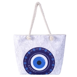 Detail of canvas beach tote with blue evil eye motif and white woven rope handles