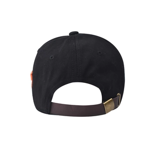 Rear view of black cotton baseball cap showing adjustable strap and brass metal buckle