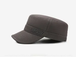 Detail of spirit embroidery on brown cotton twill flat top military cap with stitched brim