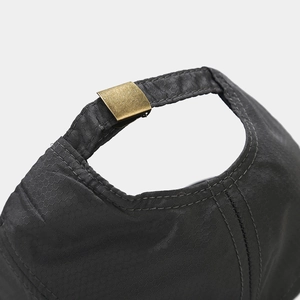 Detail of adjustable metal buckle and honeycomb ripstop nylon fabric on back of the cap