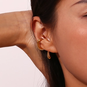 Macro shot of minimalist 18K gold plated stainless steel ear cuff on model's ear