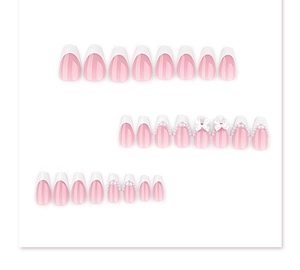 Detail of pink almond fake nails with white French tips, 3D bows, and pearls decoration