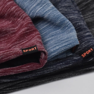Close-up of multicolored knit cotton beanies with SPORT labels in various shades