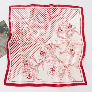 Dettaglio della stampa floreale rossa e strisce geometriche su un foulard di seta