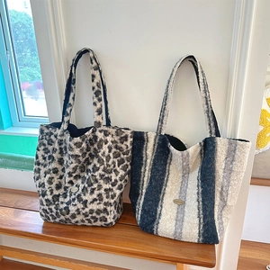 Plush leopard and blue striped tote bags showcasing soft faux fur texture and metal tags
