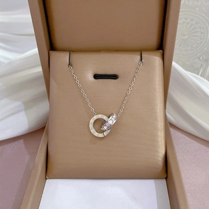 Macro view of silver double ring necklace with Roman numerals and crystals in a gift box