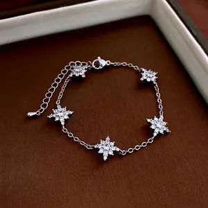 Elegant silver starburst flower bracelet with sparkling zircons and adjustable clasp