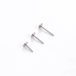 Three silver stainless steel T-shape labret studs in varying lengths on white background