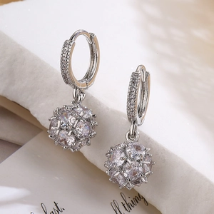 Silver geometric drop earrings with sparkling zircon disco ball pendants on white stones