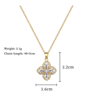 Detailed view of a gold four-leaf clover necklace with cubic zirconia and size specs
