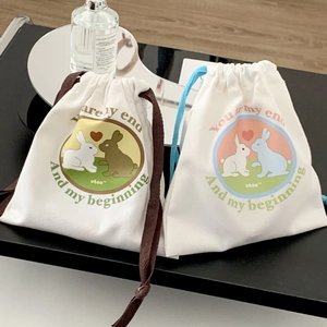 Detail of cute rabbit print drawstring canvas storage bags in blue and brown