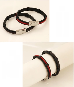 Detail of braided leather bracelet with stainless steel clasp showing secure lock mechanism