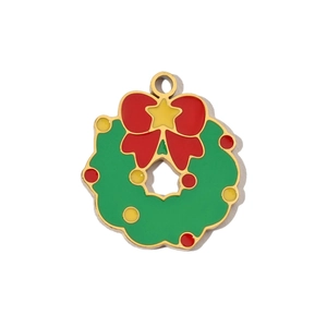 Detail of Christmas wreath pendant in green enamel with red bow and gold star accents
