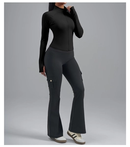Détail de la veste de yoga noire avec passe-pouces et legging évasé avec poches latérales