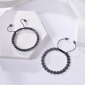 Macro view of adjustable woven bracelets with dark gray geometric and heart beads