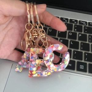 Letter A B C resin keychains with colorful heart sequins and golden metal clasps