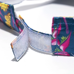 Detailed view of the adjustable hook and loop fastener on a floral print silk visor hat