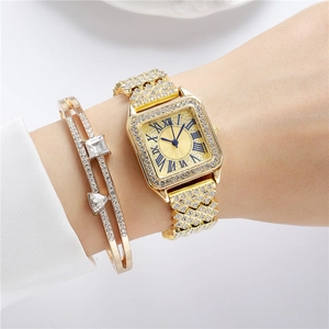 Close-up of gold square watch set with crystals and matching open bangle on wrist