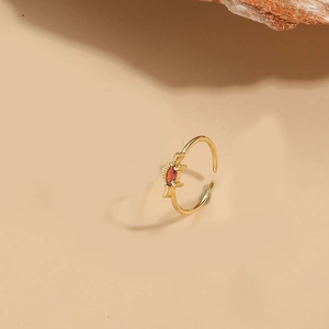 Close-up of 14K gold plated ring featuring red marquise zircon in a unique fishbone design