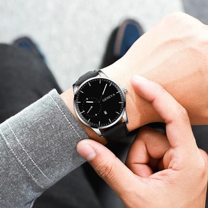 Close-up of Geneva men's watch featuring black dial and leather strap worn on wrist