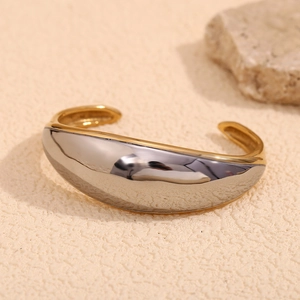 Minimalist bicolor open bangle with silver polished exterior and 18K gold plated interior