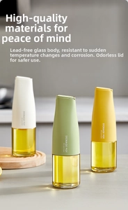 Detail view of trio non-lead glass oil dispensers in white green and yellow on kitchen counter