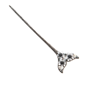Detail of silver hairpin with vintage flower patterns and white pearls on white background