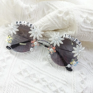 Chic bridal sunglasses with pearls, rhinestones, and Bride To Be lettering on knit