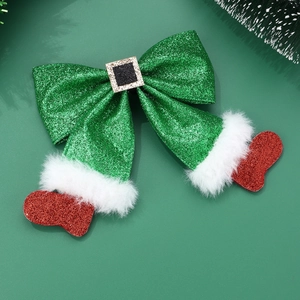 Detailed view of Christmas elf bow hair clip with green sequins and red glitter boots