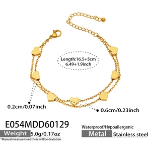 Detailed view of golden double-layer stainless steel bracelet with small heart charms