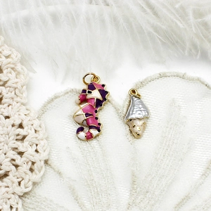 Detail of 18K gold seahorse and conch charms with colorful enamel for DIY jewelry